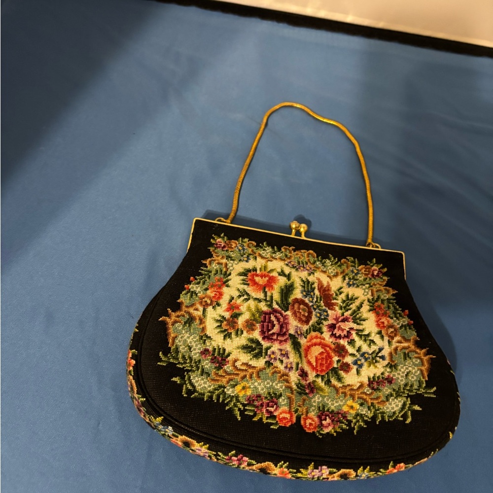 Vintage petite point handbag. Floral needlework design on a black background.